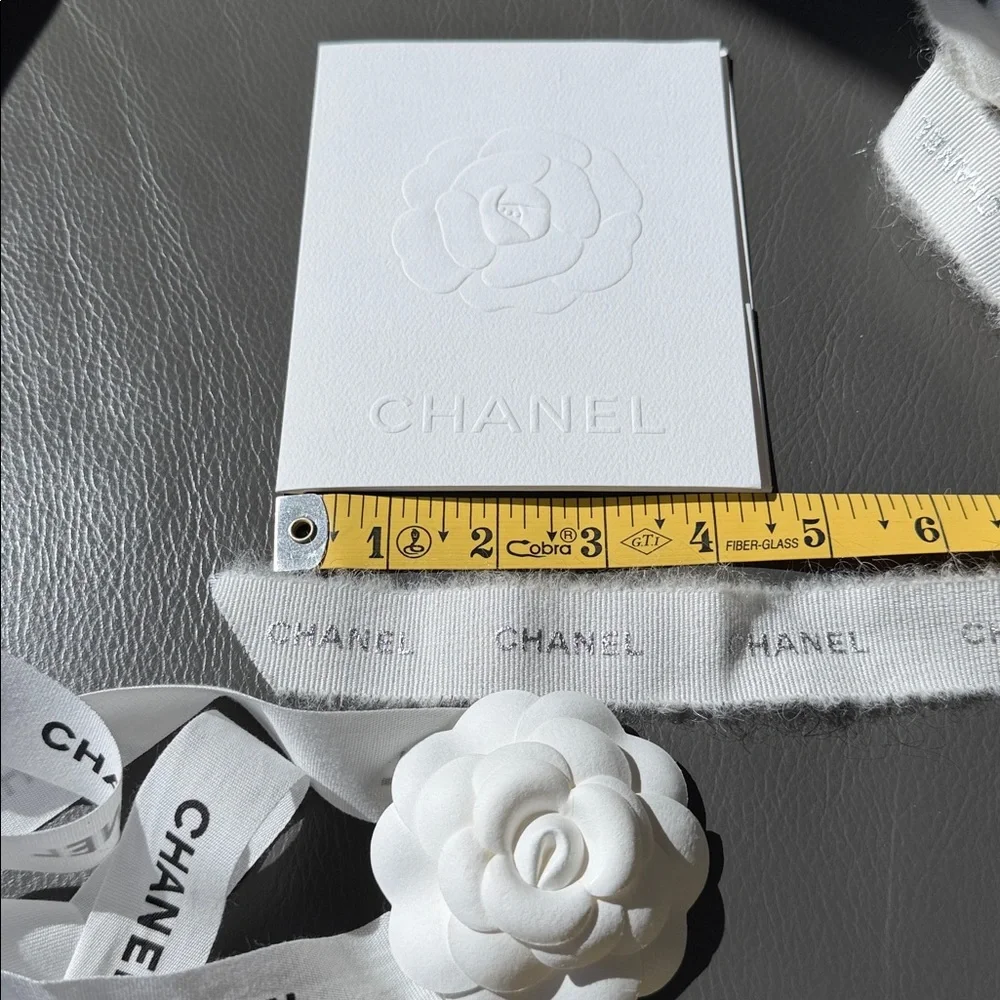 CHANEL 1 CAMELIA FLOWER AND Silver Chanel printed RIBBON,  plus Chanel card.